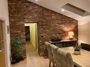 dining room with brick slips feature wall