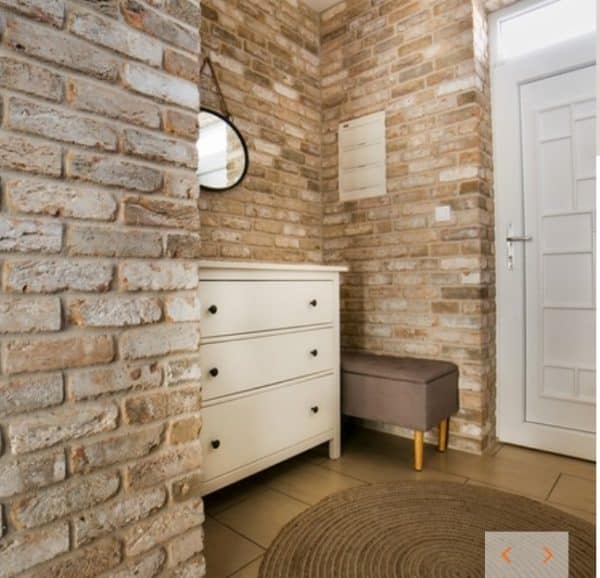 Hallway with a Sandalwood brick slip and brick tilesfeature wall